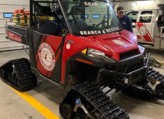 Red UTV with tracks and med unit front view